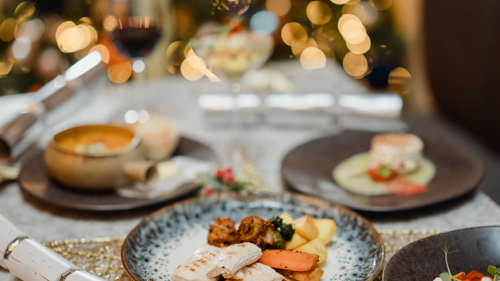 Festive dinner setting with the foreground dish in sharp focus
