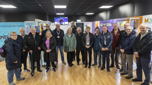 A group of people standing next to each other in the Museum of World Athletics in St Enoch's Centre in Glasgow.