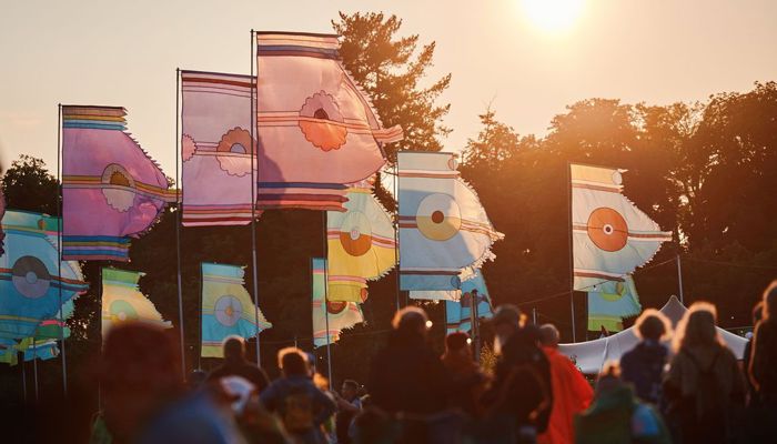 Crowds at a music festival in the sunshine